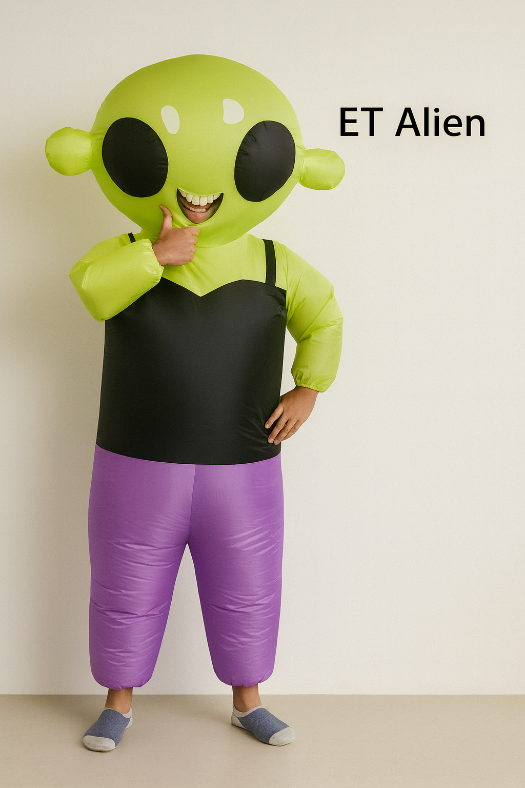 Person wearing an ET alien costume with a plain background